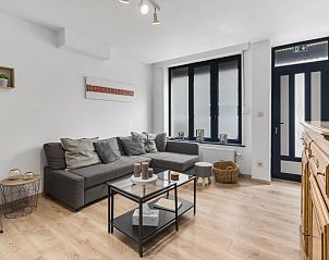 Cozy living room in vacation home Badersstraat 3, Blankenberge on the Belgian coast. Comfortable sitting area with modern furnishings.