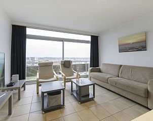 Cozy living room of Apartment Seaview 2 in Bredene, Belgian coast, with panoramic city views and comfortable seating area.
