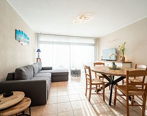 Cozy living room of Apartment Astrid 62/101 in Bredene, Belgian coast, with comfortable sitting area and dining area for a relaxing stay.
