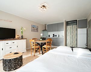 Bright interior space of Apartment Astrid 62/101 in Bredene, Belgian coast, with modern kitchen and cozy dining area.