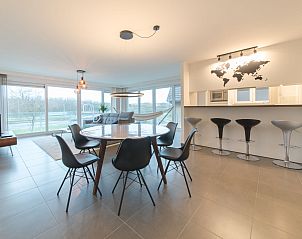 Stylish interior space of Apartment Ocean in Bredene, Belgian coast, with modern dining room and views of the surroundings.