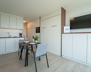 Modern interior space of Apartment Studio Zeezicht in Bredene, Belgian coast, with stylish kitchen and dining area.