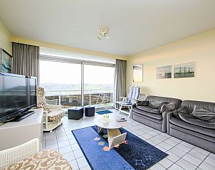 Bright living room of Apartment Residentie Astrid app. 703 in Bredene, Belgian coast, overlooking terrace and modern furnishings.