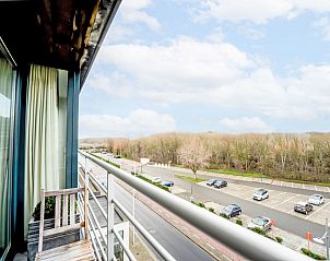 Enjoy the view from the balcony of Apartment Residentie Zeeparel in Bredene, Belgian coast, overlooking the natural surroundings.