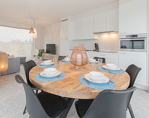 Modern dining room in Holiday Home Bredunepark, Bredene, Belgian coast, with stylish kitchen and cozy sitting area for a relaxing stay.