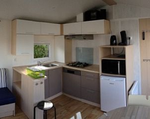 Modern kitchen inside Chalet Maldives Deluxe, vacation home in Bredene, Belgian coast, with comfortable seating area and plenty of natural light.