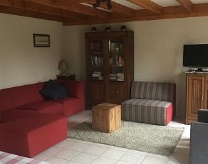 Comfortable living room Holiday home Duinhoevelaan, Bredene-aan-Zee, with cozy sitting area and television.