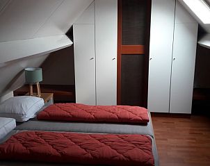 Spacious attic room in Holiday Home Duinhoevelaan, Bredene-aan-Zee, with lots of storage space and soft beds.