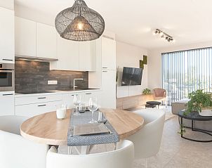 Stylish interior of Holiday Home Green in Bredene, Belgian coast, with modern kitchen and cozy sitting area.
