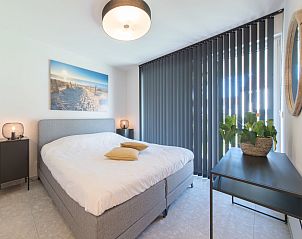 Attractive bedroom in Holiday Home Green in Bredene, Belgian coast, with modern decor and lots of natural light.