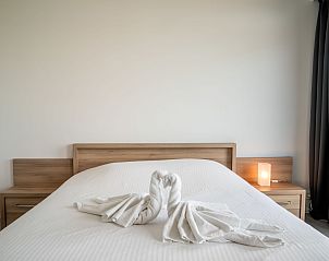Attractive bedroom in Apartment Astrid 68, Bredene, Belgian coast, with elegantly folded towels on the bed.