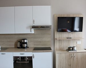 Moderne keuken in Studio | 4 Personen, vakantiehuis in Middelkerke aan de Belgische kust, met strakke kasten en een flatscreen-tv.