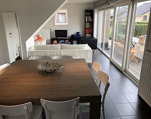 Open woon- en eetruimte in Zee en Polder nr.1 vakantiehuis, Westende, Belgische kust met uitzicht op terras.