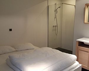 Comfortable bedroom with ensuite bathroom in bungalow in Oostduinkerke, Belgian coast.