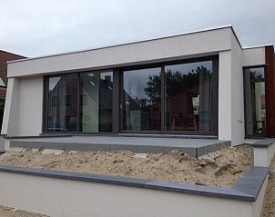 Front of bungalow in Oostduinkerke, Belgian coast, with sand garden and large terrace.