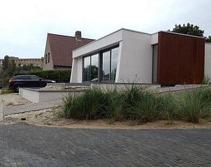 Side view of bungalow in Oostduinkerke, Belgian coast, surrounded by natural surroundings.