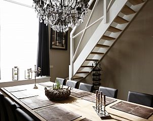 Elegant dining area in De Zeester apartment in Ostend, Belgian coast with chandelier.