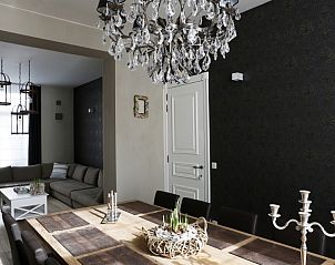 Stylish dining room in apartment De Zeester in Ostend, Belgian coast next to living room.