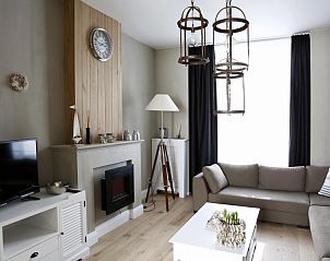 Cozy living room with fireplace in De Zeester apartment Ostend, Belgian coast.