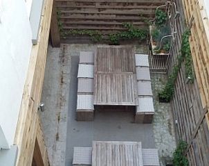 Outdoor area with wooden benches in De Zeester apartment Ostend, Belgian coast.
