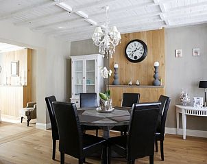 Stylish dining room in De Zeebries apartment in Ostend with wooden accents.