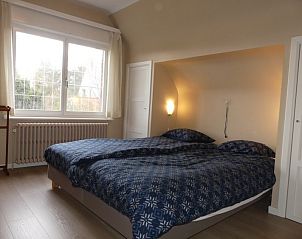 Bedroom with double bed in Villa Asteria, vacation home in Koksijde Sint-Idesbald on the Belgian coast.