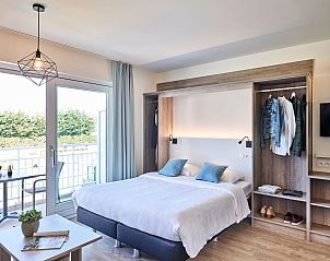 Bright bedroom in Accessible studio | 2p by the sea, Belgian coast, Belgium overlooking balcony and garden.
