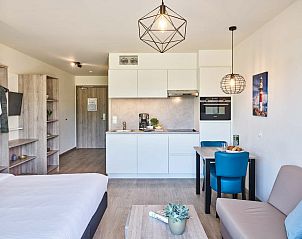 Compact kitchen in Accessible studio | 2p by the sea, Belgian coast, Belgium with dining table and modern appliances.