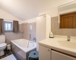 Modern bathroom in Holiday home Dunezwin, De Haan, Belgian coast, with bathtub and spacious sink. Enjoy comfort in cultural heritage.