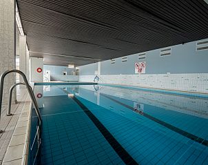 Relax in the pool of Apartment Cosy @ the beach studio with pool, a charming stay in De Haan on the Belgian coast.