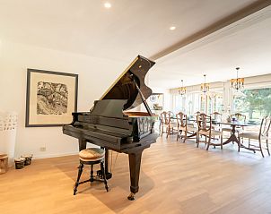 Luxury living room with grand piano in Holiday Home Villa Rosetree in De Haan, Belgian coast. Ideal space for relaxation and musical enjoyment.