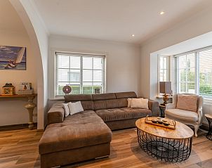 Cozy living room in Jacamar - De Haan vacation home, with comfortable sitting area and lots of light.