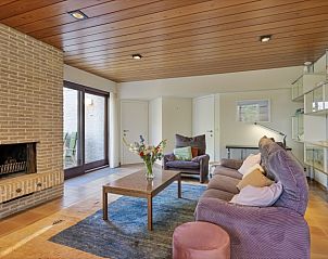 Cozy living room with fireplace in La Maison Fleurie vacation home on the Belgian coast in Koksijde.