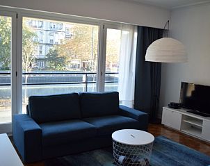 Cozy living room in Apartment in Woluwe-Saint-Lambert, Brussels with city views, comfortable sofa and modern decor.